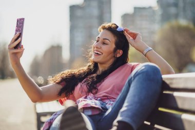 Mutlu genç bayan güneşli bir günün tadını çıkarıyor..