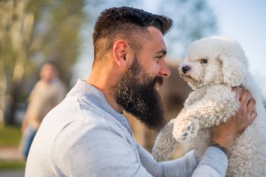 Adult man is enjoying sunny day with his dog.