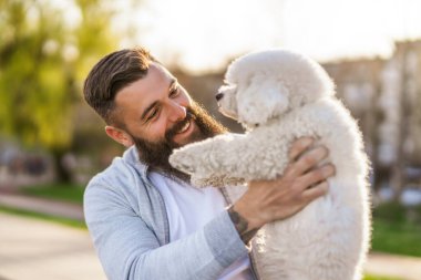 Adult man is enjoying sunny day with his dog.