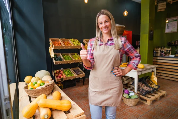 Portrait of happy food supermarket owner. Woman works in fruits and vegetables shop.