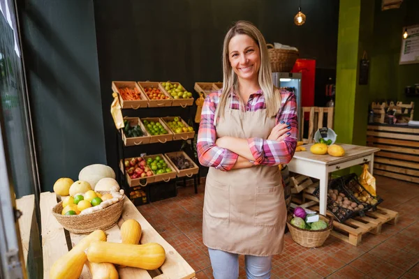 Portrait of happy food supermarket owner. Woman works in fruits and vegetables shop.