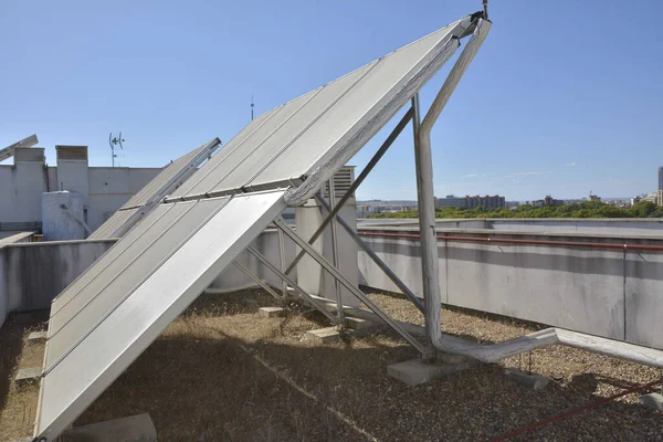 Rooftop of a building with solar panels and hot water tank