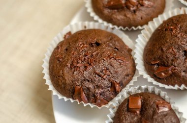 homemade chocolate muffins with icing sugar and powdered