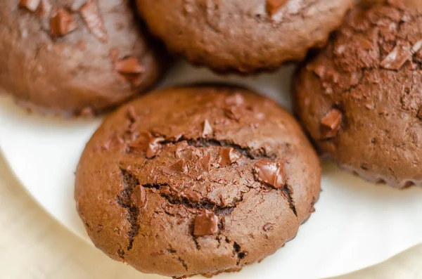 freshly baked chocolate muffins on a white background. close-up