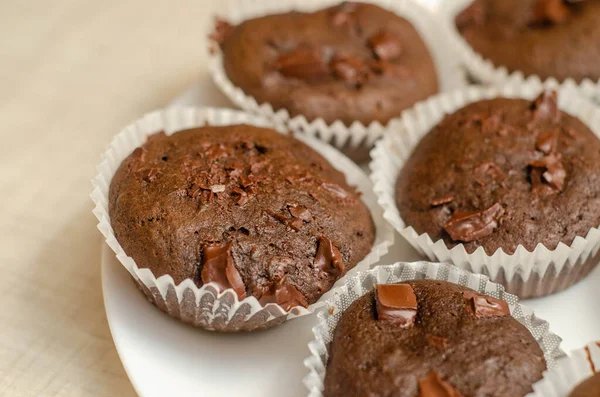 homemade muffin cakes on white wooden background
