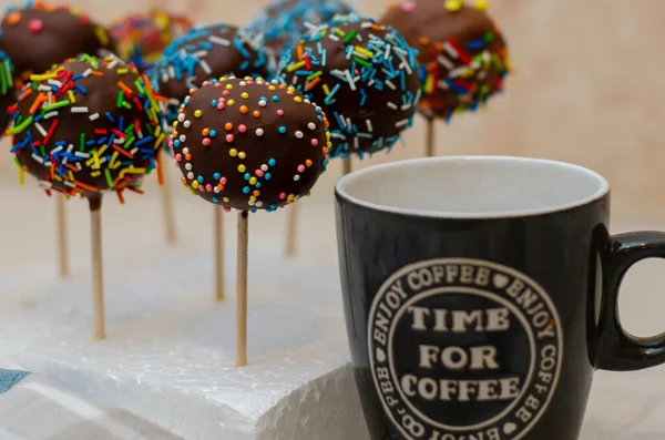 a cup of hot chocolate with a delicious cake, on a wooden background