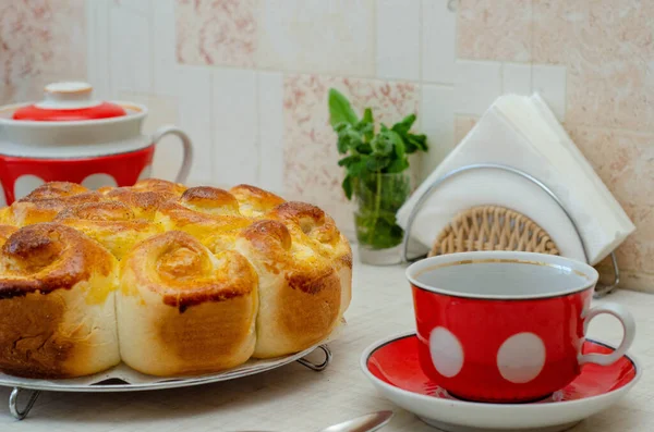 cup of tea with a slice of lemon pie and a saucer on a red plate