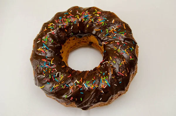 Round cupcake with chocolate torring on the white plate