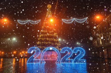 Uzhhorod, Ukraine  January 03, 2022: Night city view of the Petofi square, town center with historic architecture, Christmas and New Year decorations, festive winter cityscape, Zakarpattia