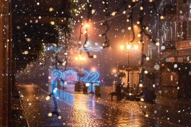 Uzhhorod, Ukraine  January 03, 2022: Night city view of the Petofi square, town center with historic architecture, Christmas and New Year decorations, festive winter cityscape, Zakarpattia