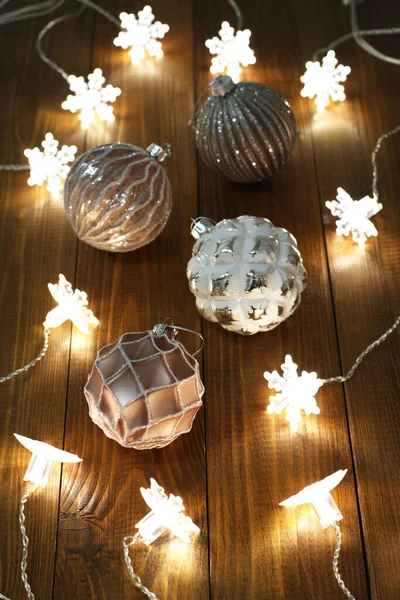 Pink White Christmas Balls Lie Brown Wooden Table Luminous Garland — Stock Photo, Image