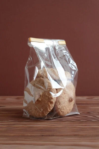 Meringue Cookies Hazelnuts Transparent Bag Wooden Table Brown Wall Closeup — Stock Photo, Image