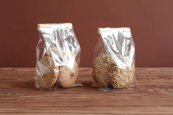 Oatmeal Cookies Sesame Seeds Meringue Cookies Hazelnuts Transparent Bags Wooden — Stock Photo, Image