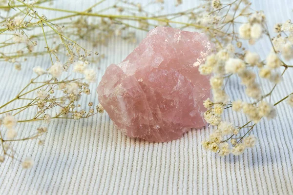 Piece of unpolished rough pink quartz as nice background. Minimal color still life photography