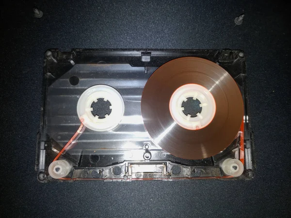 Disassembled audio cassette. Cassette film in an open case. Vintage cassette repair.