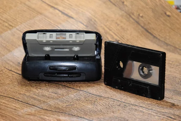 Audio cassette. Retro music medium, compact cassette for tape recorder. Retro audio cassettes next to a portable player to play compact cassettes.
