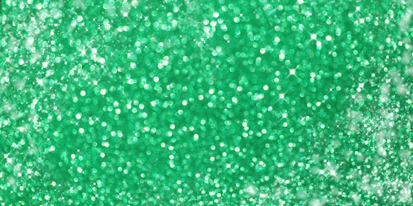 Defocused Christmas green background. Holiday abstract glitter background with blinking bokeh.Holiday glowing backdrop.Banner — Stock Photo, Image
