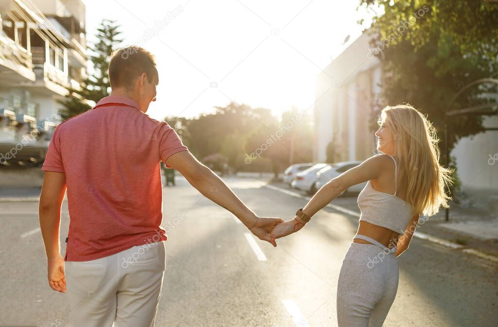 Couple has fun and laughs. Young hipster couple hugging each other in city. Summer love story, beautiful stylish young couple. Spring fashion urban concept with boyfriend and girlfriend. Select focus