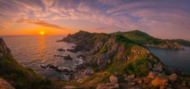Sunset over the mountains by the sea