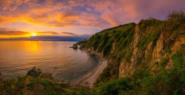 Sunset over the mountains by the sea