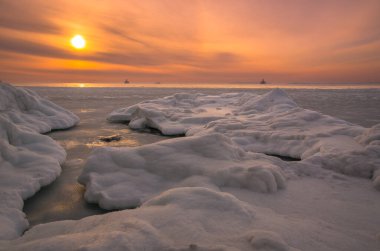 Winter sunset over the ice-bound sea
