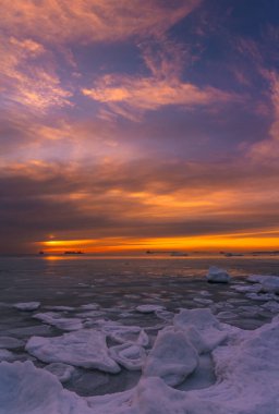 Winter sunset over the ice-bound sea
