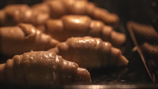 Zeitraffer von Blätterteigcroissants. Im Backofen werden Brötchen gebacken. Hausküche oder industrielle Bäckerei. Frühstücksgebäck wird abgeholt — Stockvideo