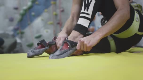 UFA RUSSIA - 09.30.21: Sportos lány sziklamászó felveszi a hegymászó cipő, lábbeli célja a sziklamászás. Felmászó ruhák. Sport hobbi a városban. — Stock videók