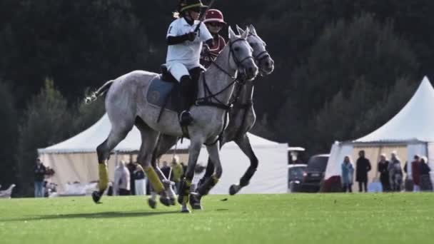 UFA RUSIA - 05.09.2021: Jugador de polo a caballo, cámara lenta. Sostiene un mazo de madera de mango largo. Partido con los espectadores, arena de hierba verde — Vídeo de stock