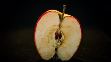 Timelapse rots red apple. The berry turns brown and dry. Time lapse shot, isolated on black background. Fruit quickly become small and wrinkled.