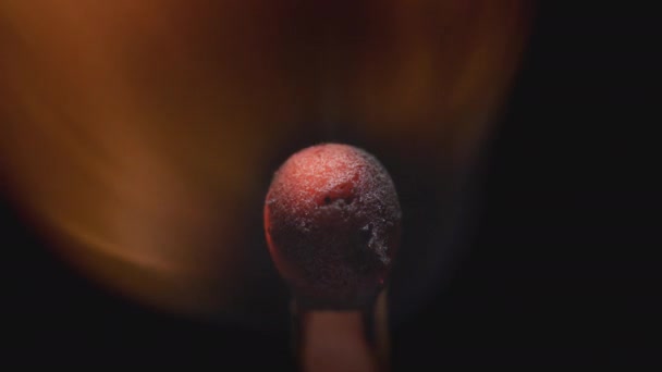 Matchstick with fire on the tip. Matchstick fires on Matchbox in macro slowmo. Macro Shot of Igniting Match against Black Background. Burning match. — Stock Video