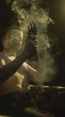 A disabled man without an arm puts on a bionic prosthesis on a stump. A full-fledged life of a guy with an artificial hand, controlled by the intellect