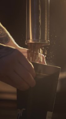 Barista wraps roasted coffee in a zip package. The coffee beans fall down. Industrial production and packaging of coffee. A man packs coffee in a bag