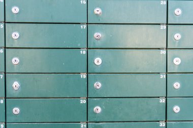 Close-up of some green metallic mailboxes