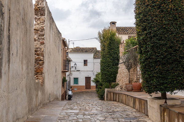 arrow, empty and cobbled street in the town of Llber (Alicante, Spain).