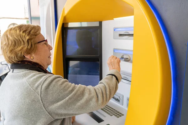 ATM 'de kredi kartı olan yaşlı bir kadın..