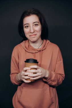 Beyaz kız stüdyoda kahve içiyor.