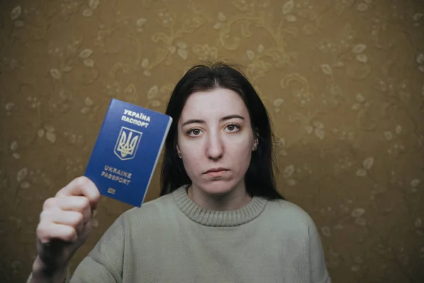 Young woman holding Ukraine passport in terminal of airport — Stock Photo, Image