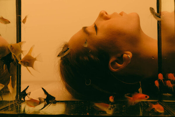 porrait of woman underwater with fish concept