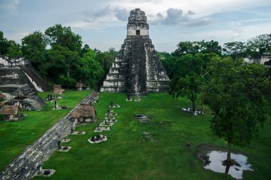 View over the main plaza to the 'Temple of the great jaguar' or 'Temple I' seen from 'Temple II' at the Maya site of Tikal, Peten, Guatemala clipart