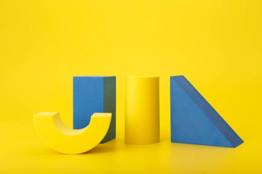Abstract futuristic background in yellow and blue colors with copy space. Geometric figures on yellow background