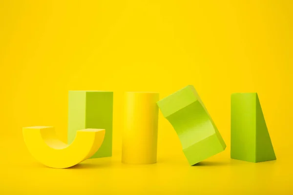 Elegant and bright futuristic composition with yellow and green geometric shapes against yellow background with copy space Royalty Free Stock Fotografie