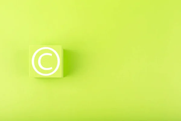 Minimal copyright and intellectual property protection concept on bright green background with copy space Imagens Royalty-Free