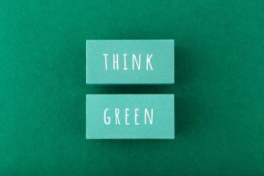 Modern composition with think green inscription on rectangles against green fluffy background. Reduce, reuse, recycle concept