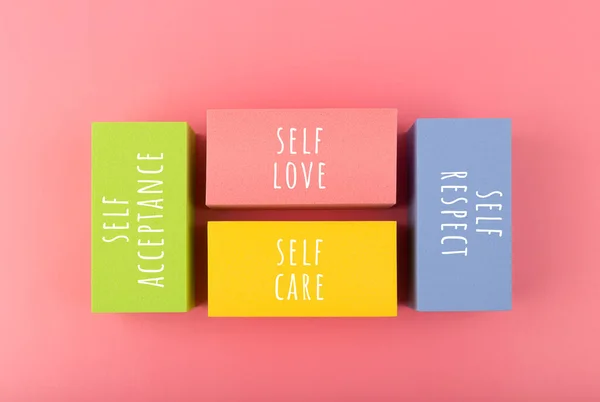 Self respect, acceptance, care and love written on multicolored rectangles. Mental health, self love and wellness concept — Fotografia de Stock
