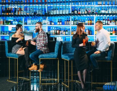 A group of friends drinks alcohol in a bar