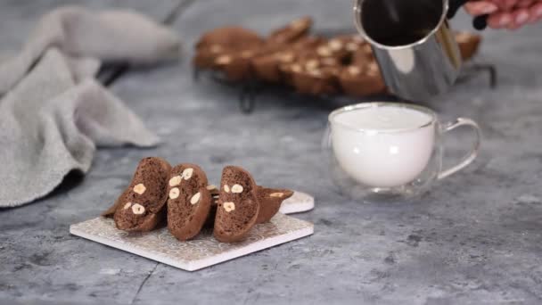 Close up of homemade chocolate and hazelnuts cookies with cup of latte. — Stock Video