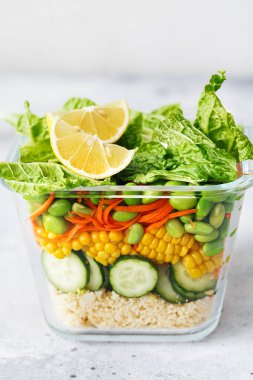 Taze çiğ sebze salatasıyla dolu cam kutu. Sağlıklı yemek tarifi hazırlama. Cam kapta sağlıklı vejetaryen yemekleri. Vejetaryen mutfağı. Bitki bazlı yemekler. Yeşil yaşam konsepti. Organik yiyecekler. 