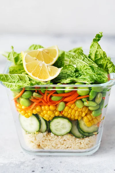 Taze çiğ sebze salatasıyla dolu cam kutu. Sağlıklı yemek tarifi hazırlama. Cam kapta sağlıklı vejetaryen yemekleri. Vejetaryen mutfağı. Bitki bazlı yemekler. Yeşil yaşam konsepti. Organik yiyecekler. 