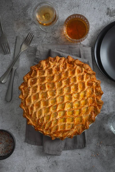 English meat pie. Pork pie. Traditional British pie. Freshly baked homemade savory pies with golden crust. Pie with pastry decoration on top. Food photography, food styling. English cuisine.